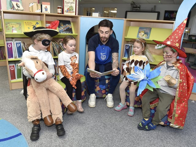 Pictured is: (middle) PFC player Owen Dale reading to some of the children.
Picture: Sarah Standing (020323-622)