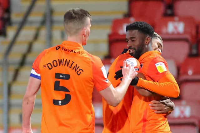 Jordy Hiwula, seen here celebrating one of his two Pompey goals against Cheltenham, is reportedly interesting Swindon. Picture: Nigel Keene/ProSportsImages