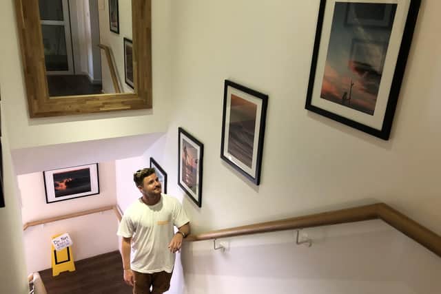 Primary school teacher Sam Rogers, from Waterlooville, has had some of his photographs displayed in a gallery at Emsworth cafe The Deck. Pictured: Sam with a few of his images
