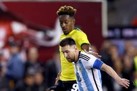 Jamal Lowe and Lionel Messi. (Photo by Elsa/Getty Images)