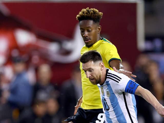 Jamal Lowe and Lionel Messi. (Photo by Elsa/Getty Images)