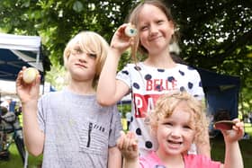 Siblings, from left, Harry Bull, 7, Mia Bull, 9, and Daisy Bull, 3, with their painted stones for wellbeing. Community Fair in Victoria Park, PortsmouthPicture: Chris Moorhouse (jpns 100721-16)