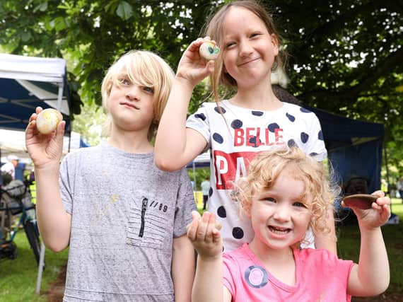 Siblings, from left, Harry Bull, 7, Mia Bull, 9, and Daisy Bull, 3, with their painted stones for wellbeing. Community Fair in Victoria Park, Portsmouth
Picture: Chris Moorhouse (jpns 100721-16)