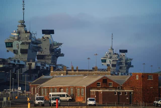 The towers of HMS Prince of Wales (left) and HMS Queen Elizabeth (right) at Portsmouth Naval Base. (Photo by Peter Summers/Getty Images)