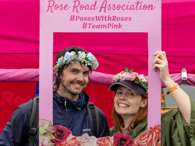 Josh Cullen (35) (attending his first festival) with Maddy Weaver (30) from Worthing at Rose Road Association garland store. Picture: Mike Cooter (240824)