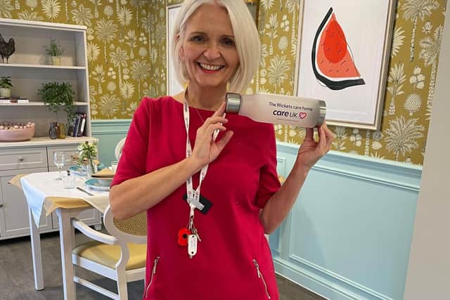 Customer Relations Manager, Nikki Toomer, showing off the care home’s free merchandise