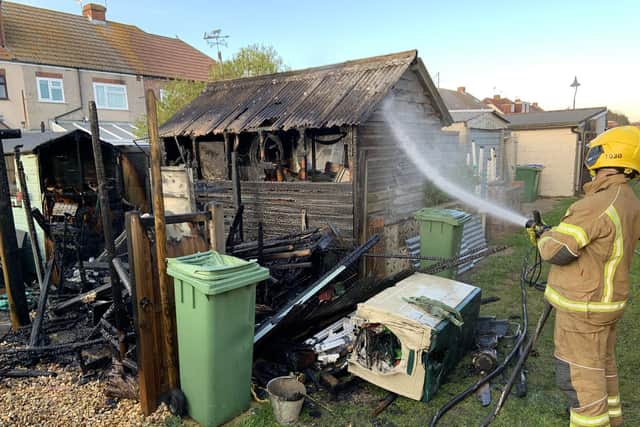 A firefighter tackles a shed blaze at Portchester on Sunday evening. Photo: Hampshire Fire and Rescue Service