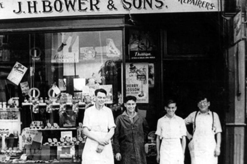 J H Bower and Sons. Dennis, third from the right, as a boy outside his late father's shop in Old Fawcett Road. To the right is his father and to his left his two brothers Roy and Eric.
.