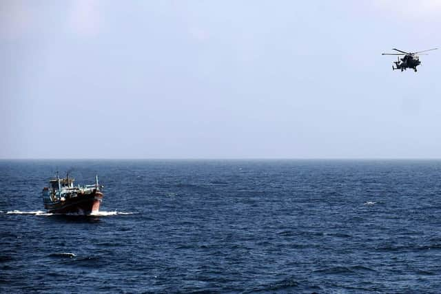 HMS Lancaster's Wildcat flies alongside the suspect dhow. Picture: Royal Navy.