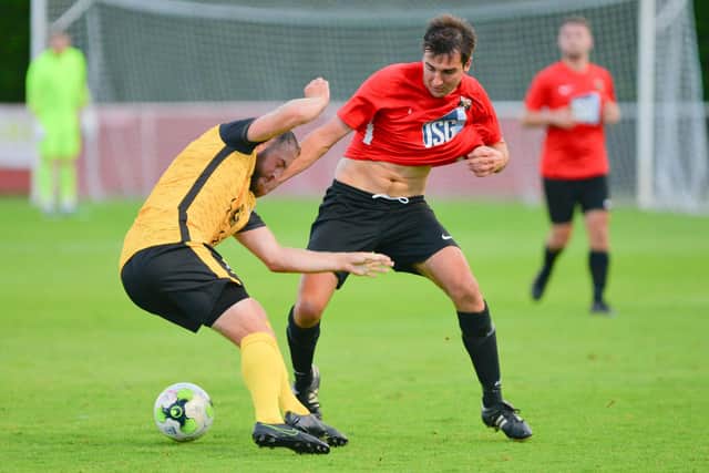 Fareham's Curt Robbins, right, and Baffins striker Alex Przesolewski. Picture: Martyn White.