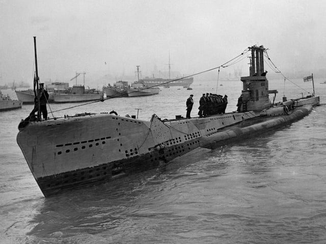 The Royal Navy Amphion-class submarine HMS Aeneas (P427) with Canadian sailors aboard for training departing HMS Dolphin submarine base near Gosport 14 January 1955 off the coast near Gosport, United Kingdom. (Photo by Fox Photos/Hulton Archive/Getty Images)