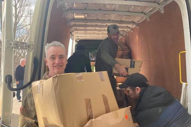 Loading donations into one of the vans.