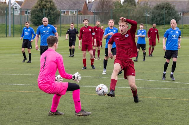 Burrfields (maroon) bear down on the Pompey Dynamos keeper. Picture: Mike Cooter