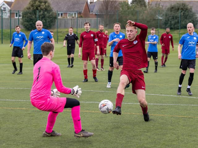 Burrfields (maroon) bear down on the Pompey Dynamos keeper. Picture: Mike Cooter
