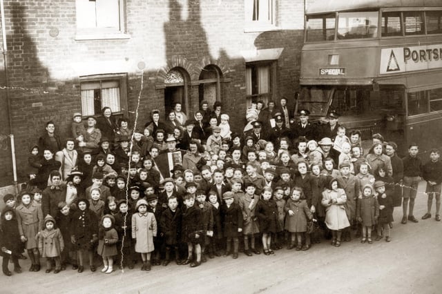 Residents gather in Buckland, Portsmouth,  with 'Bunky Doo-dalee-do' starring on accordion, real name Alfred Nicholson. The image was taken in 1945 in Sultan Road. 
Picture: Courtesy of Brian Duke