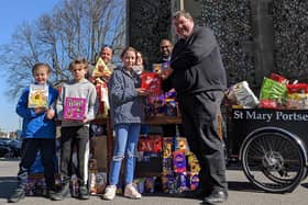 (left to right, back): Tony Mulkern, Vicki Langton, Temporary Accommodation Support Service team leader at the Roberts Centre, and the Rev Rajiv Sidhu, curate at St Mary’s Church, Fratton; (front, left to right): Shay, Tommy and Frankie Mulkern with Canon Bob White, vicar of St Mary’s Church, Fratton.