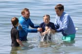 The Rev Adam Tams, the vicar of St Jude’s, Southsea (right) baptises Rebecca, 10, with children, youth and families worker Dom DeBoo.