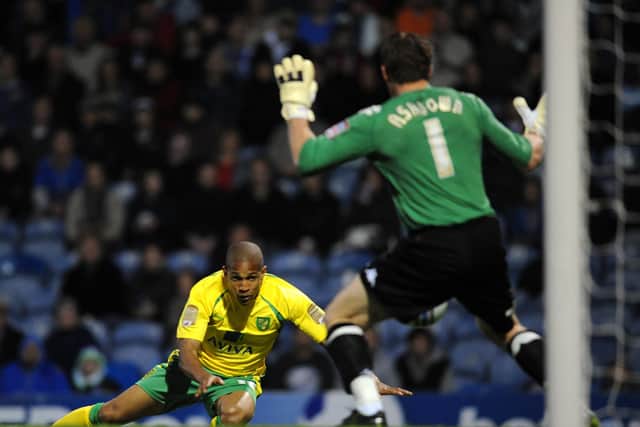 Norwich City's Simeon Jackson heads past Portsmouth's Jamie Ashdown to clinch promotion to the Premier League in 2011. Pic: Empics