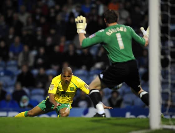 Norwich City's Simeon Jackson heads past Portsmouth's Jamie Ashdown to clinch promotion to the Premier League in 2011. Pic: Empics