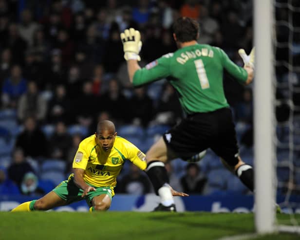 Norwich City's Simeon Jackson heads past Portsmouth's Jamie Ashdown to clinch promotion to the Premier League in 2011. Pic: Empics