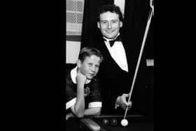 Jimmy White shows Ian Burton a trick or two during an exhibition at The Top Spot Snooker Club in Leigh Park, 1993. The News PP4529