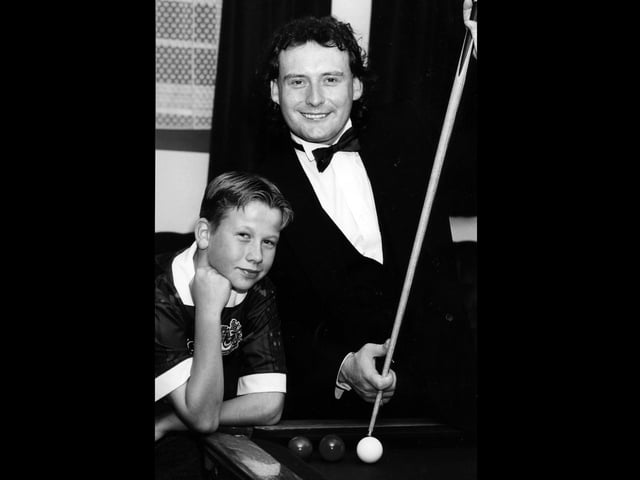 Jimmy White shows Ian Burton a trick or two during an exhibition at The Top Spot Snooker Club in Leigh Park, 1993. The News PP4529