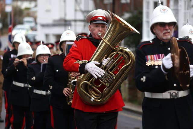 The band lead the parade through the town to the church