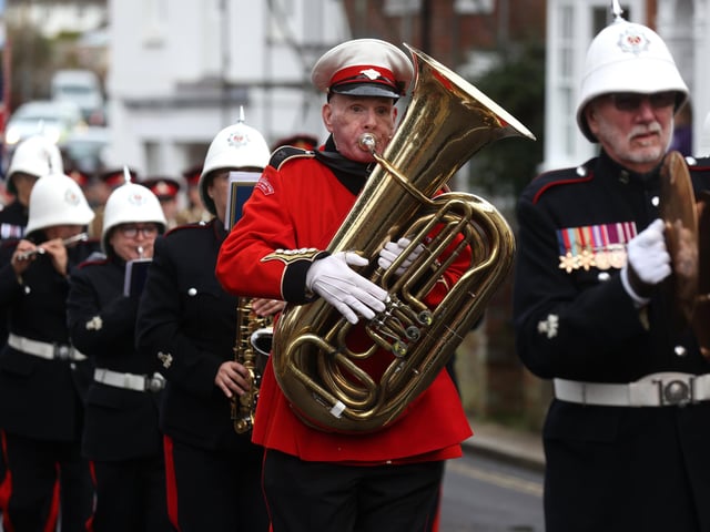 The band lead the parade through the town to the church