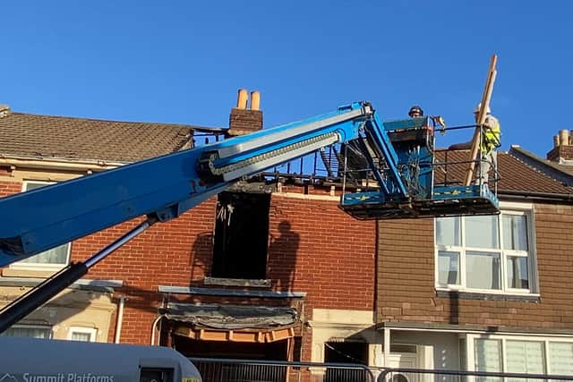 Demolition crews inspect the destroyed home in Nelson Avenue, North End. Photo: Tom Cotterill