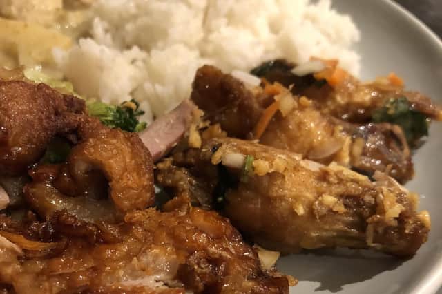 Makham duck (left), chicken wings and coconut rice from the Thailand Takeaway and Cafe