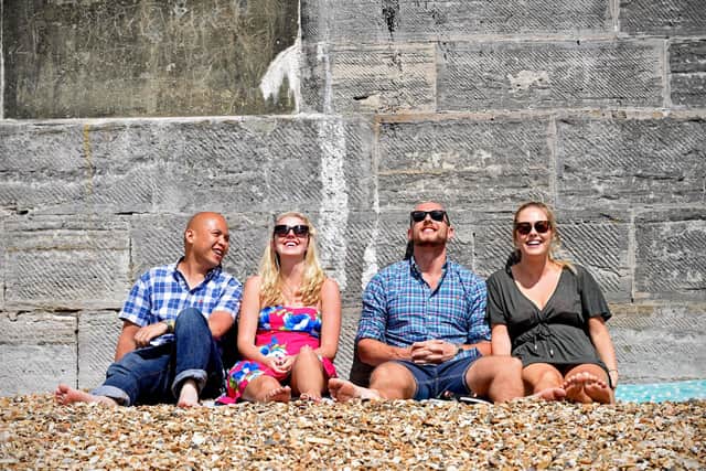 A group of friends relax in the sun at the Hot Walls in Southsea, Portsmouth. Picture: Solent News & Photo Agency