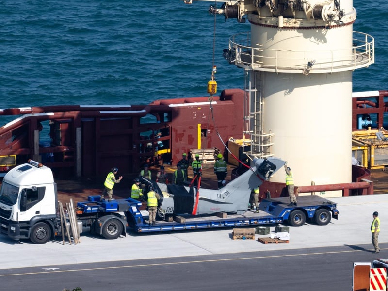 The recovered tail section of the Merlin Mk4 helicopter is bought into Portland Port, on September 18, 2024 in Portland, England. A Merlin Mk4 helicopter ditched into the sea close to HMS Queen Elizabeth while conducting night training off the Dorset coast on September 5. The pilot, Lt Rhodri Leyshon, was killed and two of the three crew from the 846 Naval Air Squadron aircraft were rescued.
