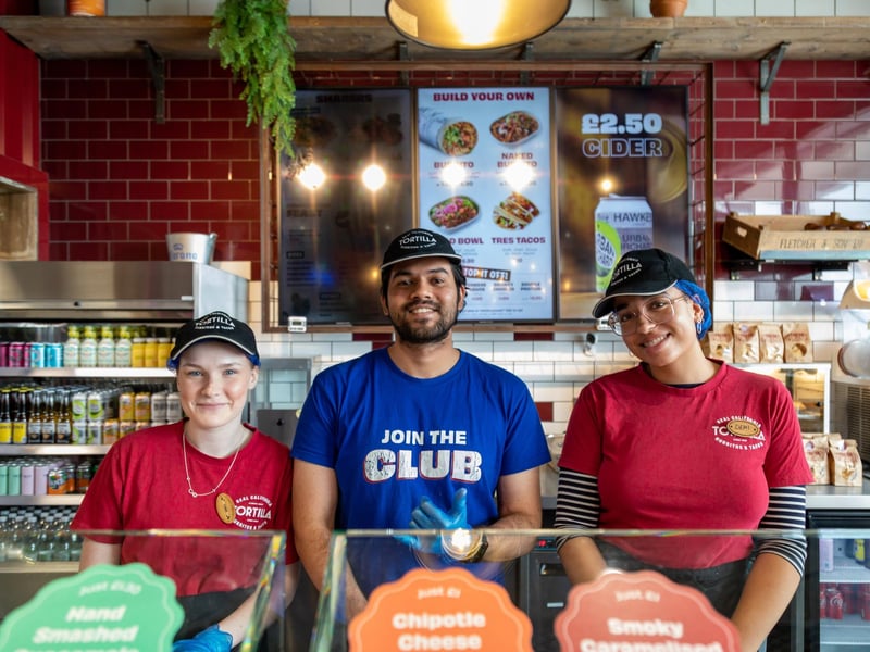 Shannon, Adwaith and Demi getting ready for the big burrito giveaway at Tortilla, Gunwharf Quays.Picture: Mike Cooter