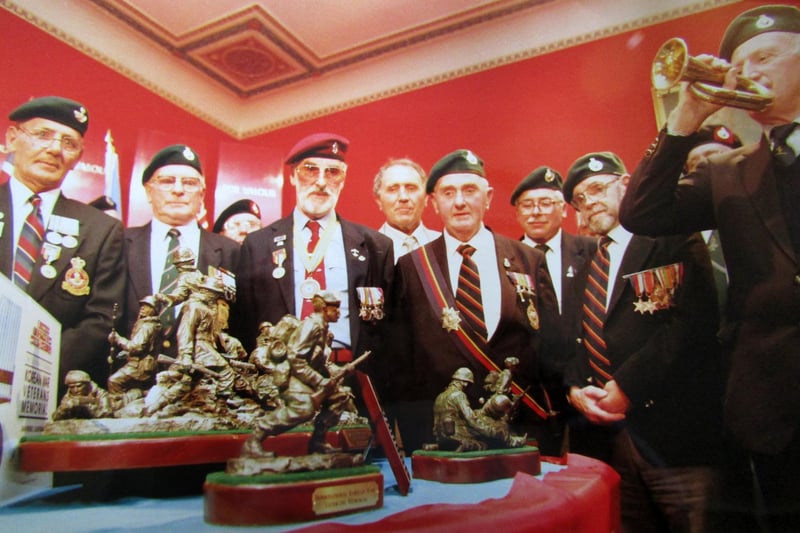 George Plim, a member of the Korean War Veterans Association plays the bugle at the presentation of the statue to the Royal Marines Museum at Eastney. 6th August 1992