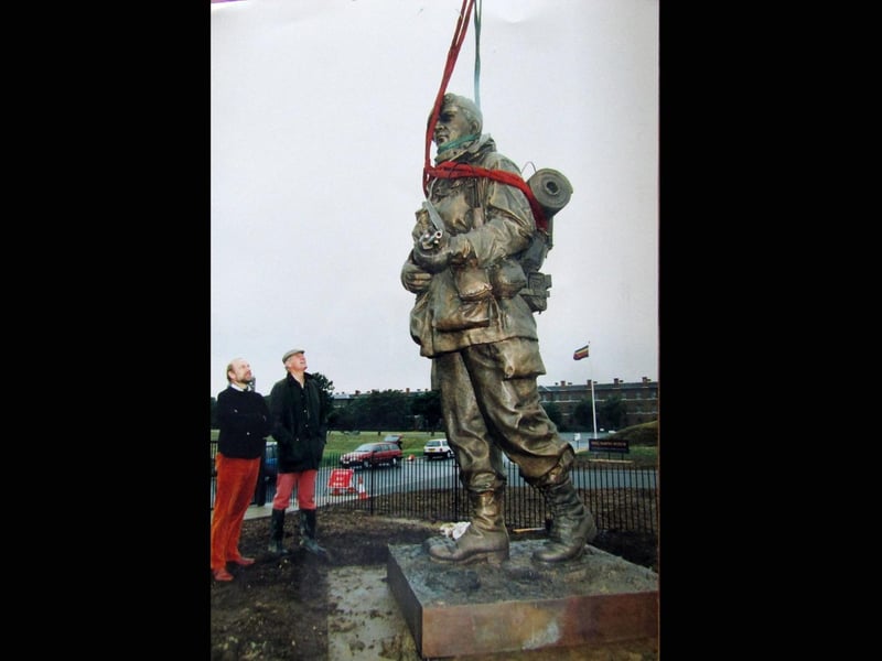 The Yomper staue being erected at the entrance to the Royal Marines Museum at Eastney, being inspected by sculptor Philip Jackson (left) and Colonel Keith Wilkins director of the museum 5th July 1992
