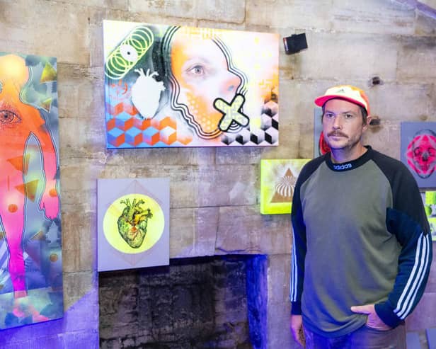 Mark Kellett with some of his work at the Out of My Mind exhibition at the Round Tower, Old Portsmouth. Picture by Matthew Clark