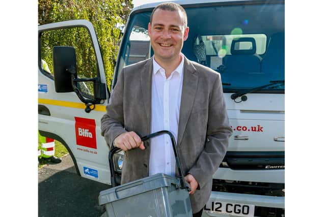 Cllr Dave Ashmore with a food waste caddy