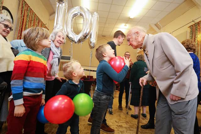 From left, Devon Smith, 8, Frank Handley, 4, and Henry Handley, 7, meet Mr Mayfield, 101, on his birthday. Boris Mayfield's 101st Birthday, Denmead Community CentrePicture: Chris Moorhouse (jpns 120322-72)