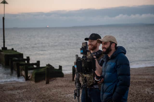 Sam Seeley, pictured right, with one of the cast members from the series - who is a serving Royal Marine - during a scene at Eastney beach