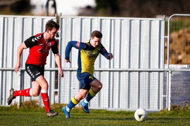Teenage striker Evan Harris gets away from his man in Moneyfields' defeat to Bournemouth Picture: Dave Bodymore