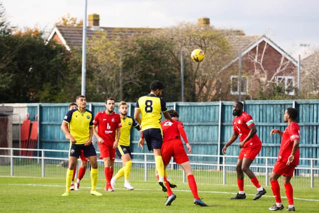 Gosport goalscorer Theo Lewis gets in a header at the Harrow goal. Pic: Tom Phillips