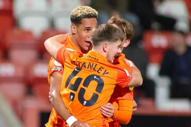 Haji Mnoga celebrates his goal with team-mates Alfie Stanley and Charlie Bell.