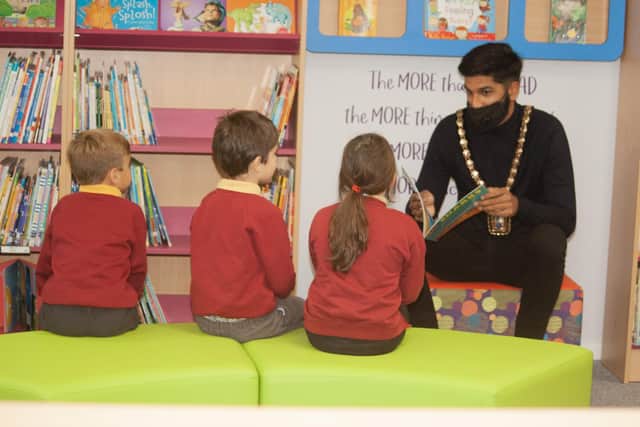 Purbrook Infant School had their parent-funded library opened by Havant mayor Prad Bains. Pictured: Cllr Bains reading to some of the children who will use the library 