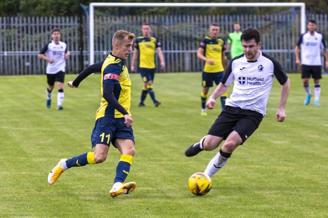 James Franklyn, left, on the ball for Moneyfields in August's FA Cup loss to AFC Stoneham. Picture: Mike Cooter