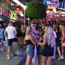 Tourists visit the popular Punta Ballena strip in Magaluf, Spain. (Photo by Clara Margais/Getty Images)