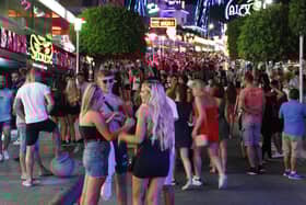 Tourists visit the popular Punta Ballena strip in Magaluf, Spain. (Photo by Clara Margais/Getty Images)