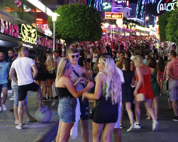 Tourists visit the popular Punta Ballena strip in Magaluf, Spain. (Photo by Clara Margais/Getty Images)