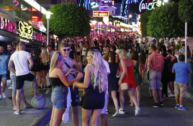 Tourists visit the popular Punta Ballena strip in Magaluf, Spain. (Photo by Clara Margais/Getty Images)
