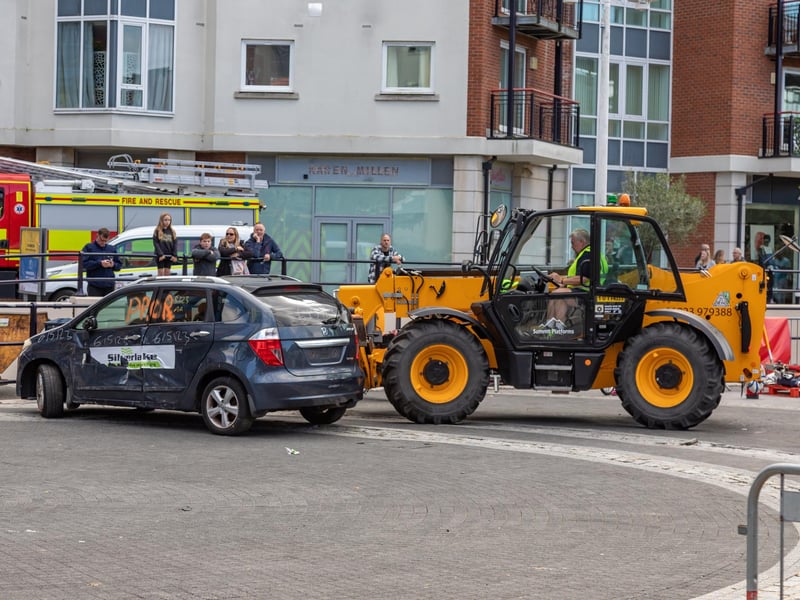 Shifting cars into place to test firefighters during the extrication challenge at Gunwharf Quays. Picture: Mike Cooter (280924)