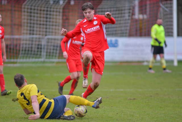 Horndean's Sam Hookey (red) v Hamworthy. Picture: Martyn White